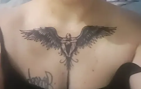 Angel with spread wings across the chest, black and gray