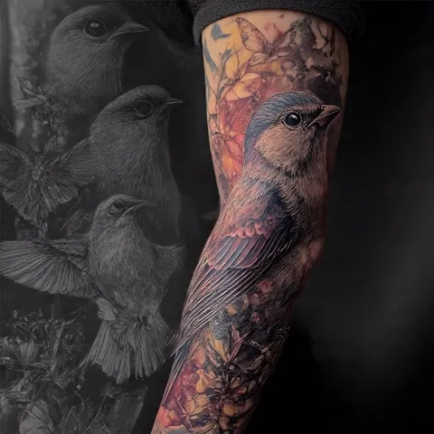 A bluebird sleeve among flowers down the arm, in color