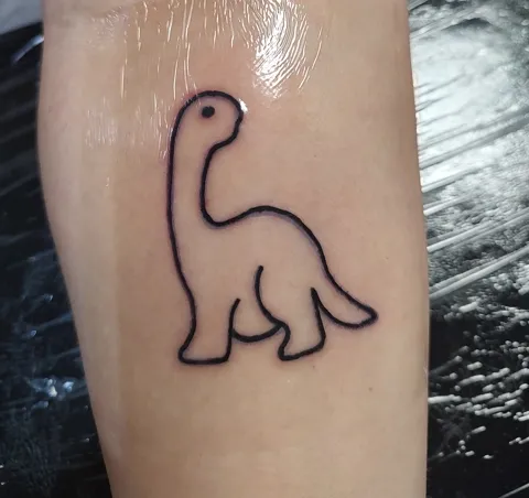 A dinosaur outline on the arm, fine line