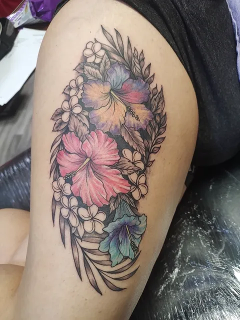 Pink and purple hibiscus with white flowers and leaves on the arm, in color