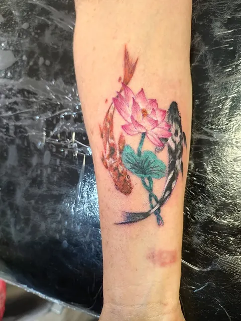 Pink lotus with a koi on the forearm, in color