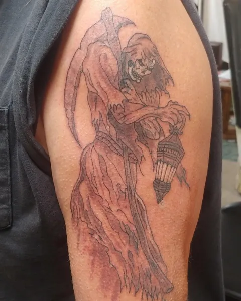 The grim reaper with a scythe and a lantern on the upper arm, black and gray