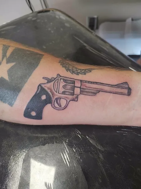 A revolver on the forearm, black and gray