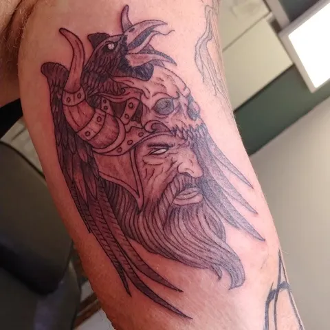 A helmeted samurai with a long beard on the forearm, black and gray