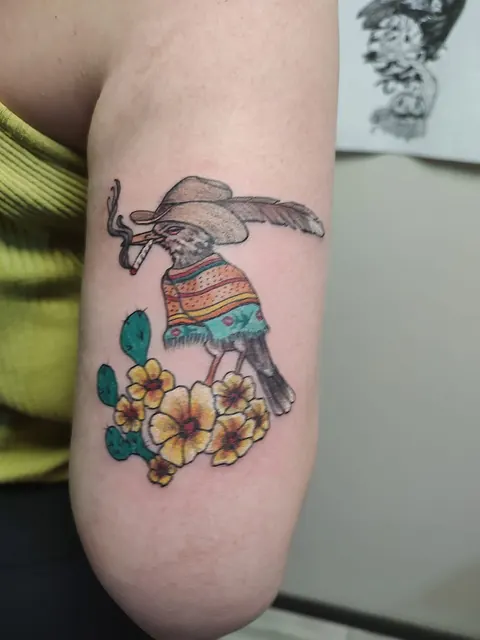 Skeleton bird in a sombrero and serape with yellow flowers, in color