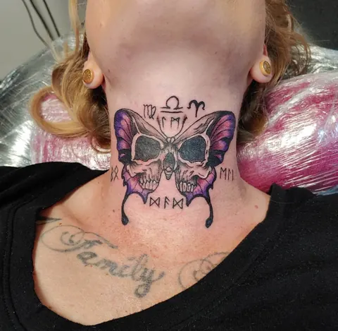 Skull inside butterfly wings with zodiac signs on the throat, in purple and pink