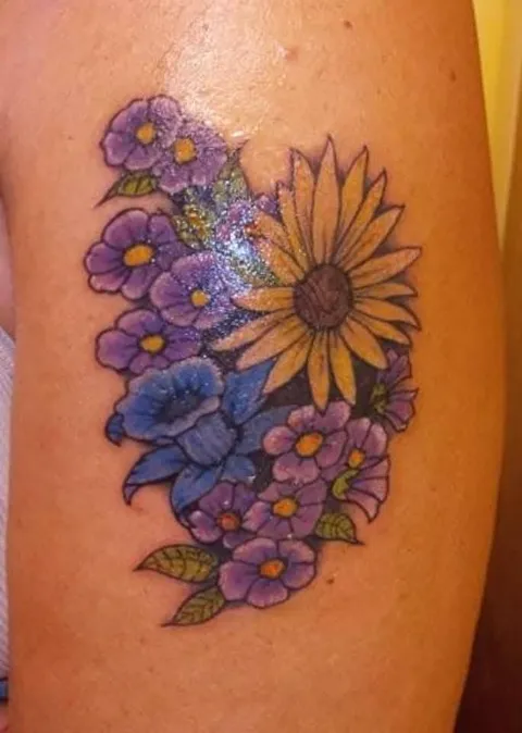 A sunflower among purple flowers, in color