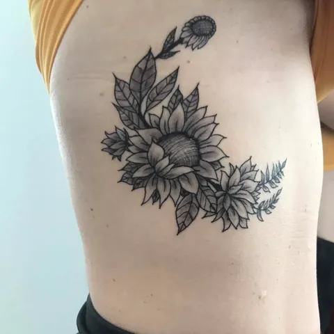 A sunflower with leaves on the side, black and gray