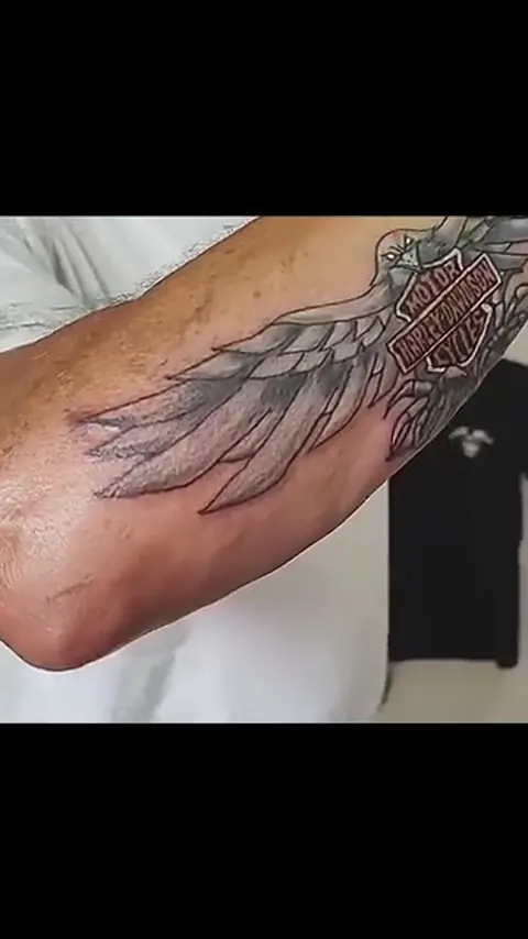 Harley-Davidson wings across the forearm, black and gray