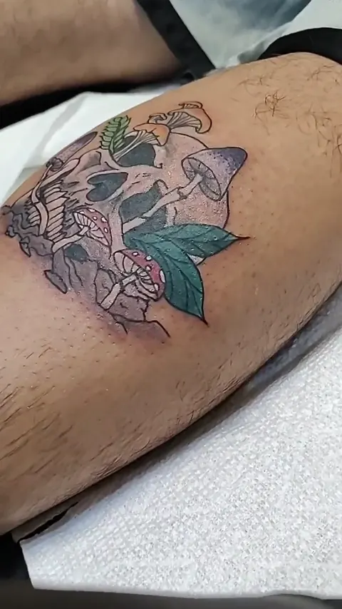 A skull sprouting mushrooms on the calf, in color