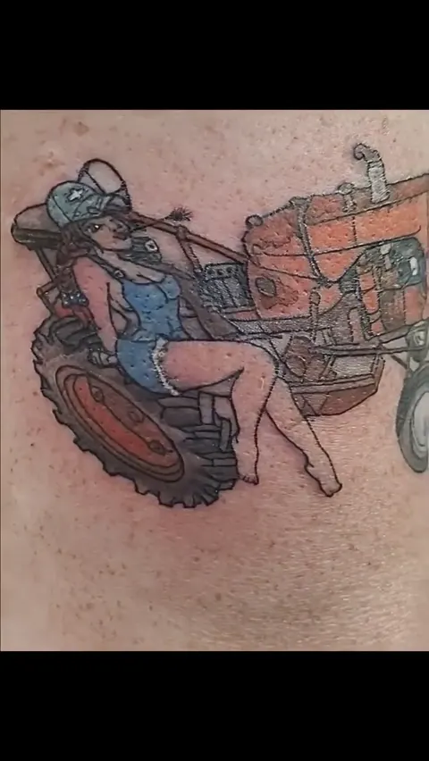 An orange tractor with a pinup on the thigh, in color